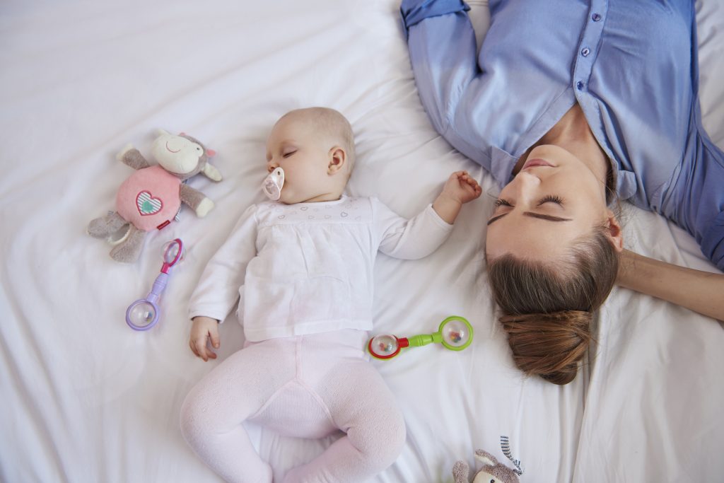 raising babies can be exhausted When Do Babies Drop to 2 Naps? The Perfect Nap Transition